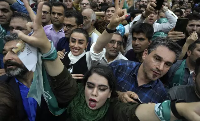Supporters of reformist candidate for Iran's presidential election Masoud Pezeshkian attend his campaign meeting in Tehran, Iran, Sunday, June 23, 2024. (AP Photo/Vahid Salemi)