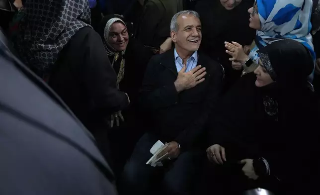 Reformist candidate for Iran's June 28, presidential election Masoud Pezeshkian greets his supporters, during a campaign rally in Tehran, Iran, Friday, June 14, 2024. (AP Photo/Vahid Salemi)