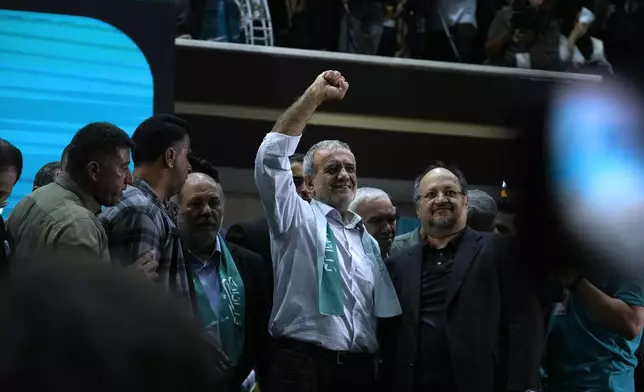 Reformist candidate for Iran's June 28, presidential election Masoud Pezeshkian clenches his fist in a campaign meeting in Tehran, Iran, Sunday, June 23, 2024. (AP Photo/Vahid Salemi)