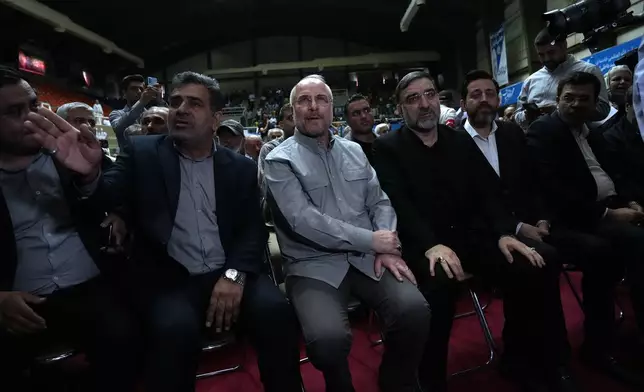 Mohammad Bagher Qalibaf, center, the most prominent candidate for the June 28, presidential election, who is Iran's parliament speaker, sits, during his campaign rally in Tehran, Iran, Tuesday, June 18, 2024. (AP Photo/Vahid Salemi)