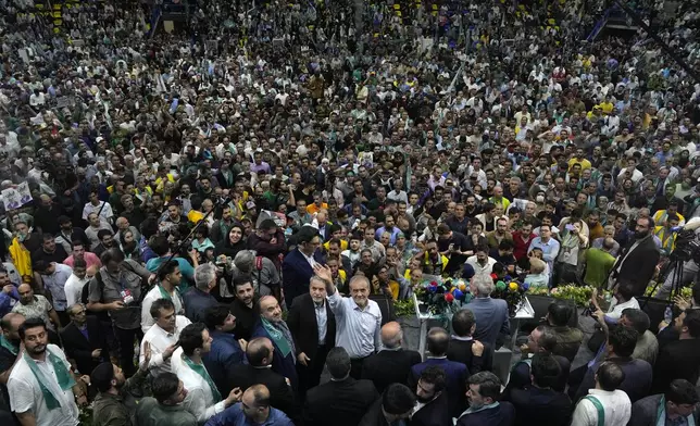 Reformist candidate for Iran's June 28, presidential election Masoud Pezeshkian, bottom center, waves to members of the media during his campaign rally in Tehran, Iran, Sunday, June 23, 2024. (AP Photo/Vahid Salemi)