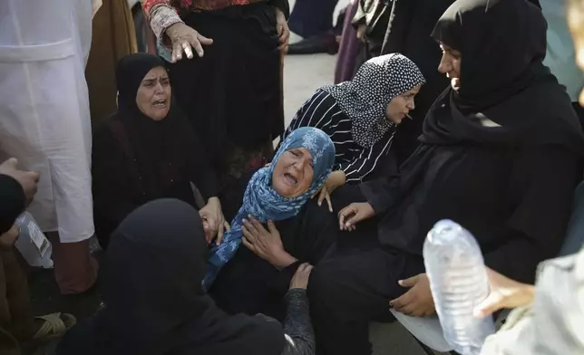 Palestinians mourn their relatives killed in the Israeli bombardment of the Gaza Strip at a hospital morgue in Khan Younis, southern Gaza Strip, Monday, June 24, 2024. (AP Photo/Jehad Alshrafi)