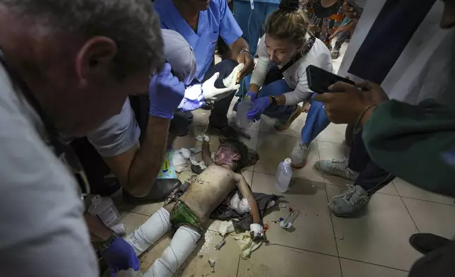 Medics treat a wounded child from an Israeli bombardment of Nuseirat refugee camp, at al-Aqsa Martyrs Hospital in Deir al Balah, central Gaza Strip, Saturday, June 29, 2024. (AP Photo/Abdel Kareem Hana)