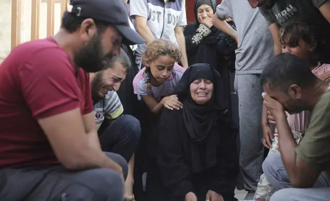 A Palestinian family mourns a loved one killed by Israeli bombardment , as they take a last look before their funeral in Khan Younis, southern Gaza Strip, Friday, June 21, 2024. (AP Photo /Jehad Alshrafi)