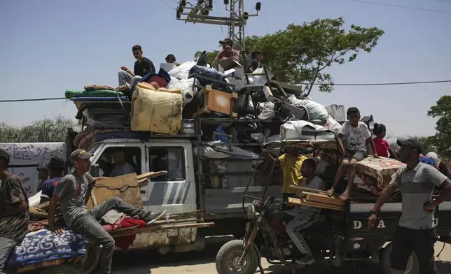 Palestinians arrive in the southern Gaza town of Khan Younis after fleeing an Israeli ground and air offensive in the nearby city of Rafah on Friday, June 28, 2024. (AP Photo/Jehad Alshrafi)