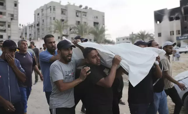Palestinians carry a person killed by Israeli bombardment to their burial in Khan Younis, southern Gaza Strip, Friday, June 21, 2024. (AP Photo /Jehad Alshrafi)