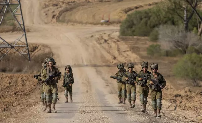 Israeli soldiers are seen near the Gaza Strip border in southern Israel, Thursday, June 13, 2024. The army is battling Palestinian militants across Gaza in the war ignited by Hamas' Oct. 7 attack into Israel. (AP Photo/Ohad Zwigenberg)