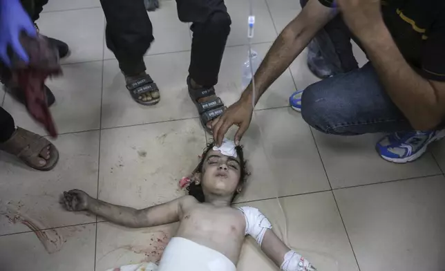 An injured Palestinian girl is treated at Al-Aqsa Martyrs Hospital in Deir al Balah, Gaza Strip, Friday, June 14, 2024. An Israeli airstrike on a home in the central city in the Gaza Strip killed two people and wounded several others including children, hospital officials said. (AP Photo/Mohammad Hajjar)