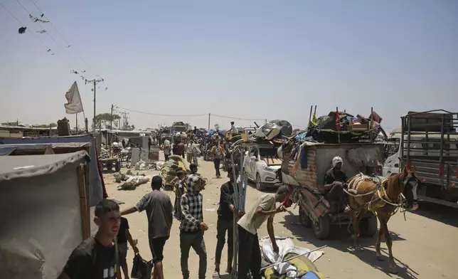 Palestinians arrive in the southern Gaza town of Khan Younis after fleeing an Israeli ground and air offensive in the nearby city of Rafah on Friday, June 28, 2024. (AP Photo/Jehad Alshrafi)
