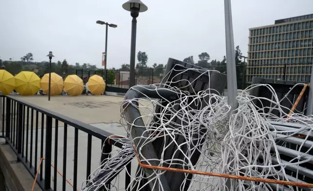 A barricade left by pro-Palestinian student protesters is seen left at California State University, Los Angeles campus in Los Angeles, Thursday, June 13, 2024. A takeover of a building at the university by demonstrators protesting Israel's war against Hamas in Gaza ended early Thursday, leaving the facility trashed and covered with graffiti, TV news reports showed. (AP Photo/Damian Dovarganes)