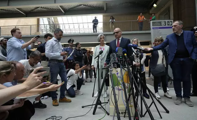 Lumumba's lawyer Carlo Pacelli speaks with reporters after the hearing at the Florence courtroom in Florence, Italy, Wednesday, June 5, 2024. Amanda Knox returns to an Italian courtroom Wednesday for the first time in more than 12½ years to clear herself "once and for all" of a slander charge that stuck even after she was exonerated in the brutal 2007 murder of her British roommate in the idyllic hilltop town of Perugia. (AP Photo/Antonio Calanni)