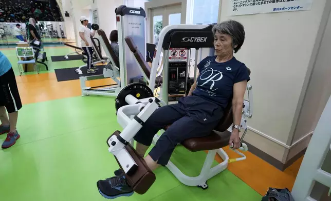 Yasuko Kuroi, 72, uses a leg extension machine as she works out at the Fukagawa Sports Center in Tokyo, Wednesday, June 12, 2024. If you are getting up there in years, weight-resistance training might deliver unexpected benefits. (AP Photo/Hiro Komae)