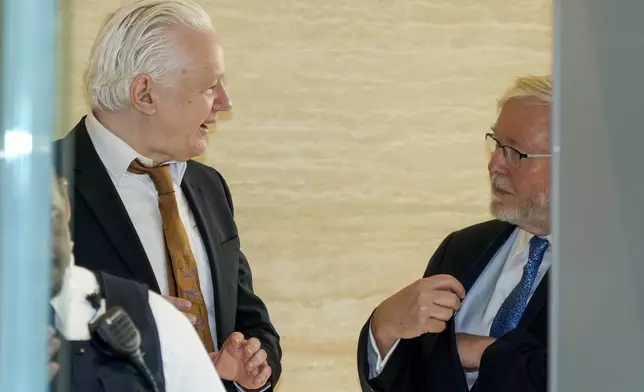 WikiLeaks founder Julian Assange, left, talks to Australian ambassador to the United States Kevin Rudd as he is brought to court to enter a plea deal, in Saipan, Mariana Islands, Wednesday, June 26 2024. (AP Photo/Eugene Hoshiko)