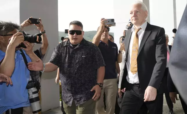 WikiLeaks founder Julian Assange, right, arrives at the United States courthouse where he is expected enter a plea deal, in Saipan, Mariana Islands, Wednesday, June 26 2024. (AP Photo/Eugene Hoshiko)