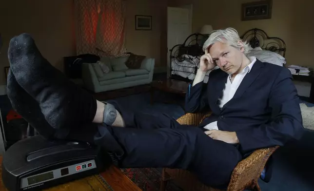 FILE - WikiLeaks founder Julian Assange is seen with his ankle security tag at the house where he is required to stay, near Bungay, England, Wednesday, June 15, 2011. Assange will plead guilty to a felony charge in a deal with the U.S. Justice Department that will free him from prison and resolve a long-running legal saga over the publication of a trove of classified documents. (AP Photo/Kirsty Wigglesworth, File)