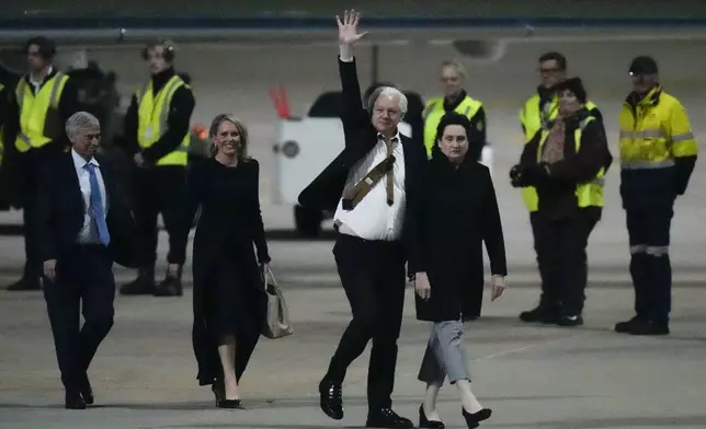 FILE - WikiLeaks founder Julian Assange waves after landing at RAAF air base Fairbairn in Canberra, Australia, June 26 2024. The abrupt guilty plea by WikiLeaks founder Julian Assange was the culmination of negotiations that began a year and a half ago and accelerated in recent months. (AP Photo/Rick Rycroft, File)