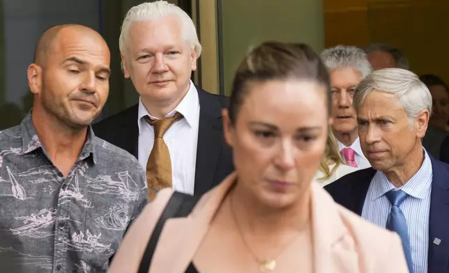 WikiLeaks founder Julian Assange, second left, leaves the federal court in Saipan, Mariana Islands, Wednesday, June 26 2024. (AP Photo/Eugene Hoshiko)