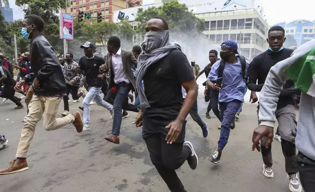 Demonstrators run from police during a protest over proposed tax hikes in a finance bill that is due to be tabled in parliament in Nairobi, Kenya, Thursday, June 20, 2024. AP Photo/ Andrew Kasuku)