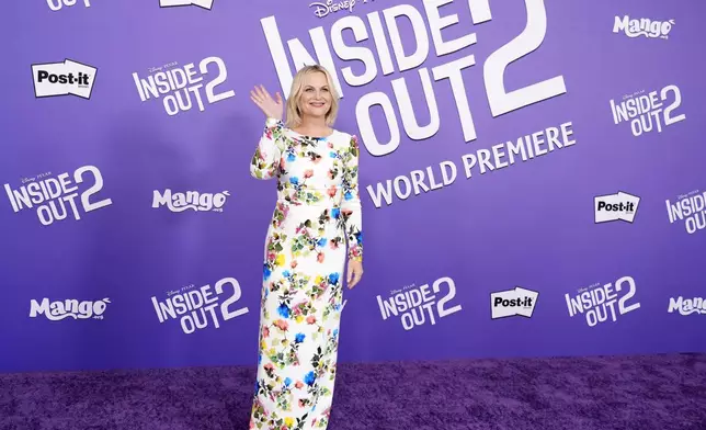 Amy Poehler, a cast member in "Inside Out 2," waves to photographers at the premiere of the film at the El Capitan Theatre, Monday, June 10, 2024, in Los Angeles. (AP Photo/Chris Pizzello)