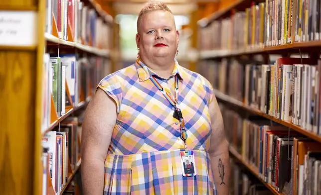 June Meissner poses for a photo at the Boise Public Library in Boise, Idaho on Thursday, June 6, 2024. Meissner, a transgender woman and librarian, blocked a punch from a man yelling slurs while working at the library. (AP Photo/Kyle Green)