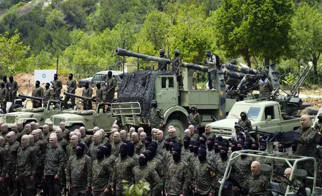 FILE - Fighters from the Lebanese militant group Hezbollah carry out a training exercise in Aaramta village in the Jezzine District, southern Lebanon, Sunday, May 21, 2023. Thousands of fighters from Iran-backed groups in the Middle East are offering to come to Lebanon to join the militant Hezbollah group in its fight with Israel. (AP Photo/Hassan Ammar, File)