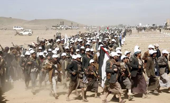 FILE - Houthi fighters march during a rally of support for the Palestinians in the Gaza Strip and against the U.S. strikes on Yemen outside Sanaa on Monday, Jan. 22, 2024. Thousands of fighters from Iran-backed groups in the Middle East are offering to come to Lebanon to join the militant Hezbollah group in its fight with Israel. (AP Photo, File)