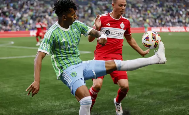 Seattle Sounders midfielder Léo Chú volleys the ball past Chicago Fire defender Arnaud Souquet during the first half of an MLS soccer match Saturday, June 29, 2024 in Seattle. (Jennifer Buchanan/The Seattle Times via AP)
