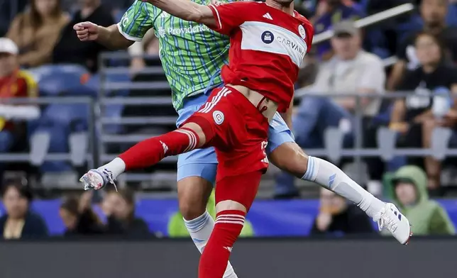 Chicago Fire forward Hugo Cuypers, front, goes up for a header with Seattle Sounders defender Jackson Ragen during the second half of an MLS soccer match Saturday, June 29, 2024 in Seattle. (Jennifer Buchanan/The Seattle Times via AP)