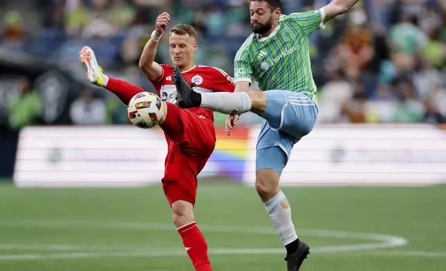 Seattle Sounders midfielder João Paulo, right, and Chicago Fire midfielder Fabian Herbers go up for the ball during the first half of an MLS soccer match Saturday, June 29, 2024 in Seattle. (Jennifer Buchanan/The Seattle Times via AP)