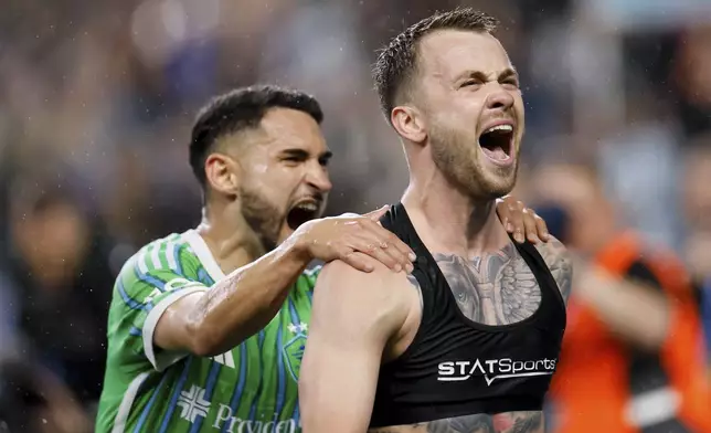 Seattle Sounders midfielder Cristian Roldan, left, celebrates with Albert Rusnák after Rusnák scored on a penalty kick against the Chicago Fire during the second half of an MLS soccer match Saturday, June 29, 2024 in Seattle. (Jennifer Buchanan/The Seattle Times via AP)