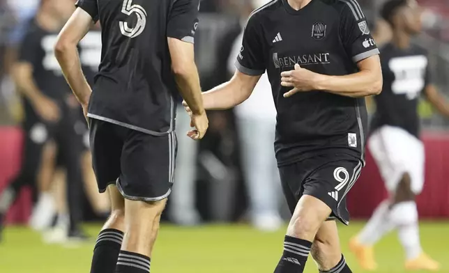 Nashville SC forward Sam Surridge (9) celebrates his team's win against Toronto FC with teammate Jack Maher following a MLS soccer game in Toronto, Wednesday, June 19, 2024. (Mark Blinch/The Canadian Press via AP)