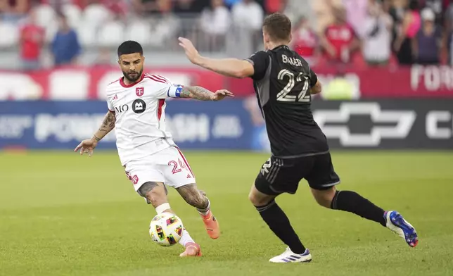 Toronto FC forward Lorenzo Insigne (24) moves the ball against Nashville SC defender Josh Bauer (22) during the first half of a MLS soccer game in Toronto, Wednesday, June 19, 2024. (Mark Blinch/The Canadian Press via AP)