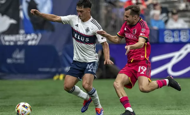 Vancouver Whitecaps' Sebastian Berhalter (16) and St. Louis City's Indiana Vassilev (19) vie for the ball during the second half of an MLS soccer match Saturday, June 29, 2024, in Vancouver, British Columbia. (Ethan Cairns/The Canadian Press via AP)
