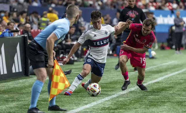 Vancouver Whitecaps' Sebastian Berhalter and St. Louis City's Indiana Vassilev, right, vie for the ball during the second half of an MLS soccer match Saturday, June 29, 2024, in Vancouver, British Columbia. (Ethan Cairns/The Canadian Press via AP)