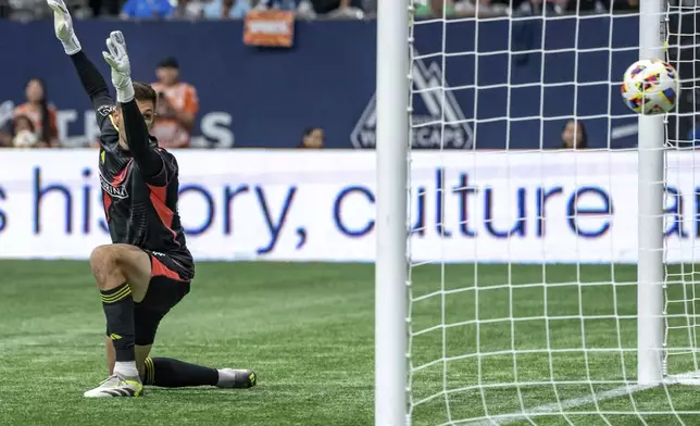 St. Louis City goalkeeper Ben Lundt gives up a goal to Vancouver Whitecaps Fafa Picault during the second half of an MLS soccer match Saturday, June 29, 2024, in Vancouver, British Columbia. (Ethan Cairns/The Canadian Press via AP)