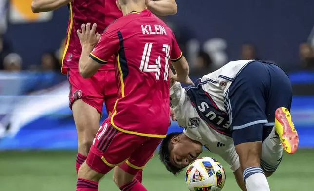 St. Louis City's Chris Durkin, back left, and John Klein (41) and Vancouver Whitecaps' Mathias Laborda compete for the ball during the first half of an MLS soccer match Saturday, June 29, 2024, in Vancouver, British Columbia. (Ethan Cairns/The Canadian Press via AP)