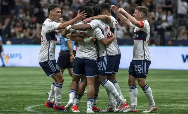 Vancouver Whitecaps' Brian White (24), second from right, celebrates with teammates after scoring a goal against St. Louis City during the second half of an MLS soccer match Saturday, June 29, 2024, in Vancouver, British Columbia. (Ethan Cairns/The Canadian Press via AP)