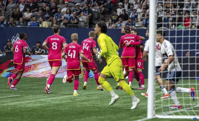 St. Louis City's Eduard Loewen (10) celebrates with teammates after scoring against the Vancouver Whitecaps during the first half of an MLS soccer match Saturday, June 29, 2024, in Vancouver, British Columbia. (Ethan Cairns/The Canadian Press via AP)
