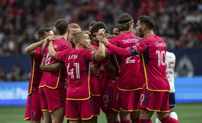 St. Louis City celebrates after jabulo Blom, obscured, scored against the Vancouver Whitecaps during the first half of an MLS soccer match Saturday, June 29, 2024, in Vancouver, British Columbia. (Ethan Cairns/The Canadian Press via AP)