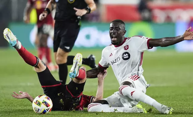 Toronto FC forward Prince Owusu, right, reacts after being fouled by New York Red Bulls midfielder Daniel Edelman, front left, during an MLS soccer match, Saturday, June 22, 2024, in Harrison, N.J. (AP Photo/Julia Nikhinson)