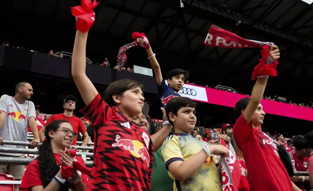 Fans react during an MLS soccer match between Toronto FC and the New York Red Bulls, Saturday, June 22, 2024, in Harrison, N.J. (AP Photo/Julia Nikhinson)