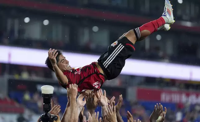 New York Red Bulls players toss up midfielder Frankie Amaya following an MLS soccer match against Toronto FC, Saturday, June 22, 2024, in Harrison, N.J. The Red Bulls won 3-0. (AP Photo/Julia Nikhinson)