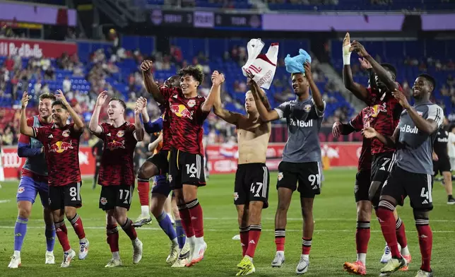 New York Red Bulls players celebrate following an MLS soccer match against Toronto FC, Saturday, June 22, 2024, in Harrison, N.J. (AP Photo/Julia Nikhinson)