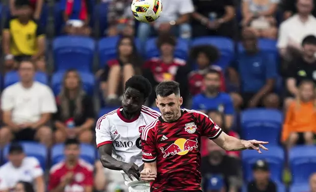 Toronto FC forward Cassius Mailula, left and New York Red Bulls defender Sean Nealis, right, battle for a header during an MLS soccer match, Saturday, June 22, 2024, in Harrison, N.J. (AP Photo/Julia Nikhinson)