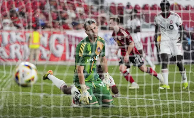 Toronto FC goalkeeper Luka Gavran, left, watches a goal by New York Red Bulls forward Cameron Harper during an MLS soccer match, Saturday, June 22, 2024, in Harrison, N.J. (AP Photo/Julia Nikhinson)