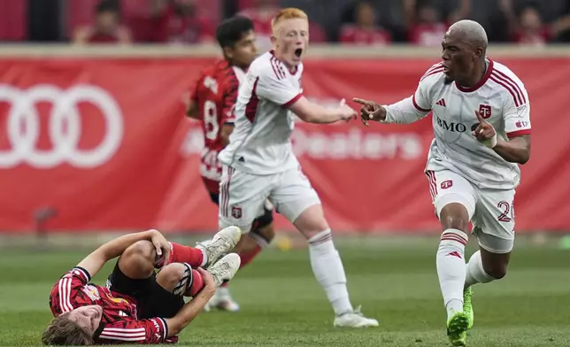 New York Red Bulls midfielder Daniel Edelman, left, reacts, after tripping over Toronto FC midfielder Deybi Flores, right, during an MLS soccer match, Saturday, June 22, 2024, in Harrison, N.J. (AP Photo/Julia Nikhinson)