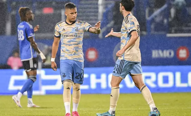 Philadelphia Union's Jesus Bueno (20) celebrates with Leon Flach (31) after scoring against CF Montreal during the first half of an MLS soccer match Saturday, June 29, 2024, in Montreal. (Graham Hughes/The Canadian Press via AP)
