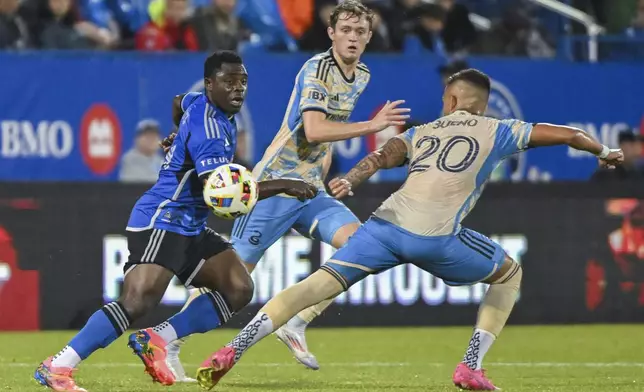 CF Montreal forward Sunusi Ibrahim, left, tries to get around Philadelphia Union's Jesús Bueno (20) during the second half of an MLS soccer match in Montreal, Saturday, June 29, 2024. (Graham Hughes/The Canadian Press via AP)