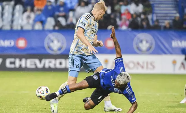CF Montreal's Josef Martínez (17) falls next to Philadelphia Union defender Jakob Glesnes, left, during the first half of an MLS soccer match Saturday, June 29, 2024, in Montreal. (Graham Hughes/The Canadian Press via AP)