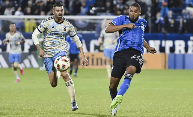 CF Montreal's George Campbell, right, plays a pass as Philadelphia Union's Tai Baribo, front left, moves in during the second half of an MLS soccer match in Montreal, Saturday, June 29, 2024. (Graham Hughes/The Canadian Press via AP)